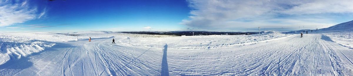 Scenic view of snowcapped mountains against cloudy sky