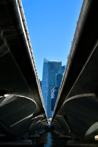 Low angle view of bridge over sea in city