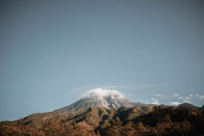 Low angle view of volcanic mountain against sky