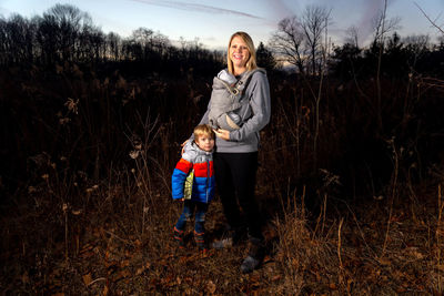 Full length portrait of happy girl on field