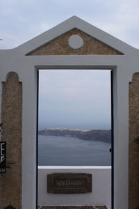 Building against sky seen through window