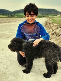 Portrait of boy with poodle dog