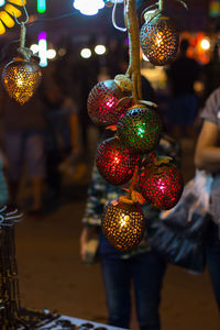 Illuminated christmas decorations hanging at night