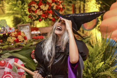 Happy woman wearing wizard costume during halloween