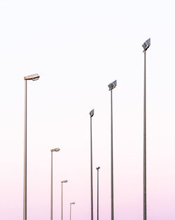 Low angle view of street lights against clear sky