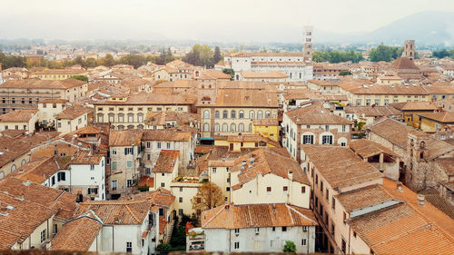 High angle view of houses in town against sky