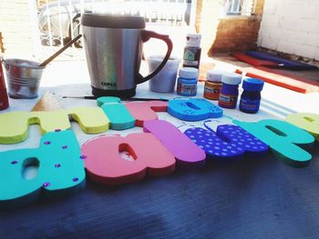 Close-up of multi colored coffee cup on table