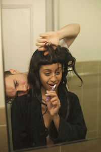 Young woman brushing her teeth