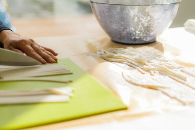 Close-up of person preparing food on table