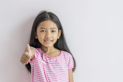 Portrait of a smiling girl over white background