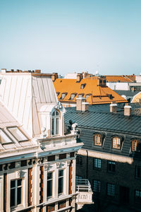 Buildings in city against clear blue sky