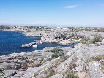 Aerial view of town by sea against sky