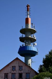 Low angle view of lighthouse against clear blue sky