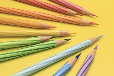 Close-up of multi colored pencils on table