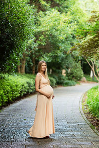 Young woman standing on footpath