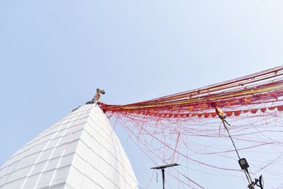 Low angle view of ferris wheel against building