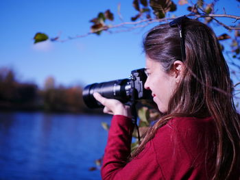 Portrait of woman photographing