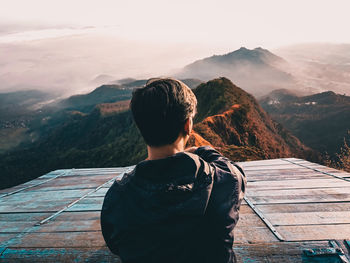 Rear view of boy looking at mountain range