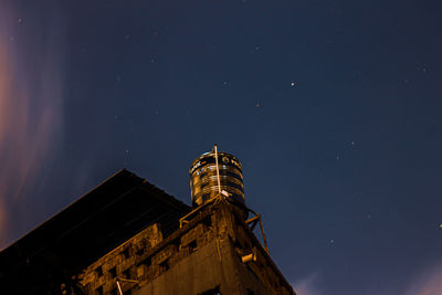 Low angle view of illuminated building against sky at night