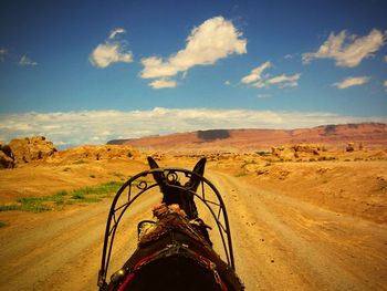 Scenic view of desert road against sky