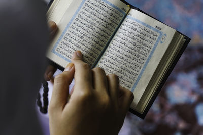 Cropped image of hand holding book