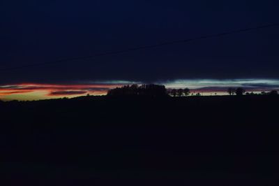 Silhouette landscape against sky at sunset