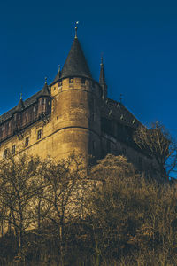 Low angle view of building against clear blue sky