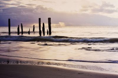 Scenic view of beach against sky during sunset