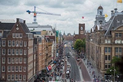 View of cityscape against cloudy sky