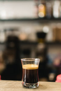 Close-up of espresso in glass on table