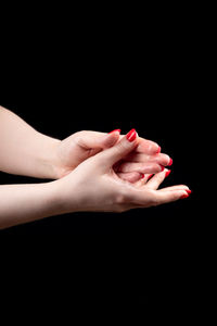 Low section of woman against black background