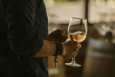 Midsection of man having drink