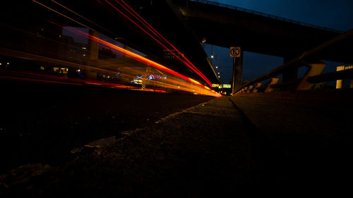 Illuminated bridge in city at night