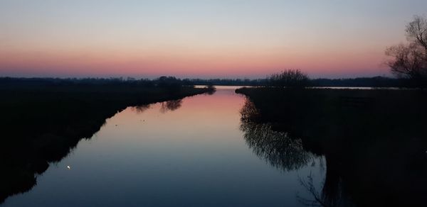 Scenic view of lake against sky during sunset