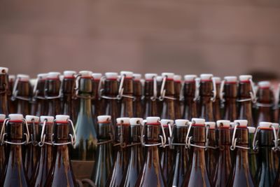 Close-up of beer bottles in row