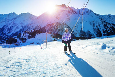 Rear view of man skiing on snow covered mountain