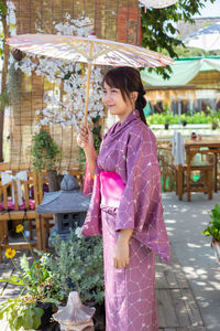 Side view of young woman standing outdoors