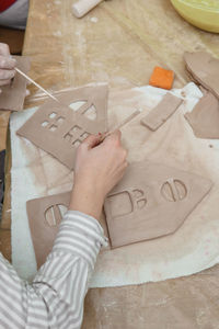 Women's hands knead clay, drawing elements of the product. production of ceramic products 