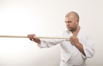 Portrait of man standing against white background