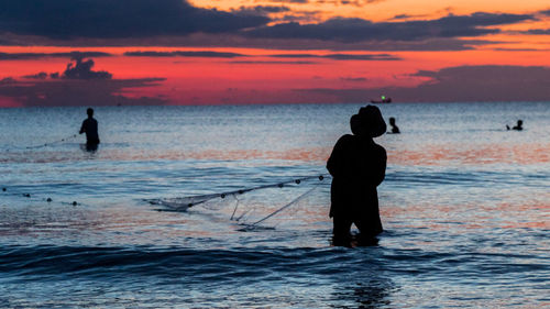 A fisherman is fishing at sunset on koh rong, cambodia