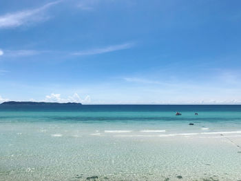 Scenic view of sea against blue sky