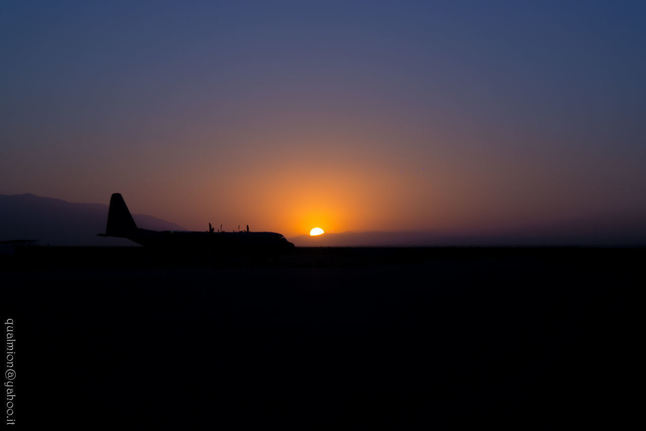 SILHOUETTE LANDSCAPE AGAINST CLEAR SKY AT SUNSET