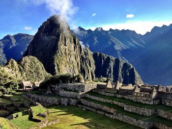 Scenic view of mountains against cloudy sky