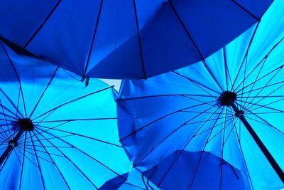 Low angle view of blue umbrellas