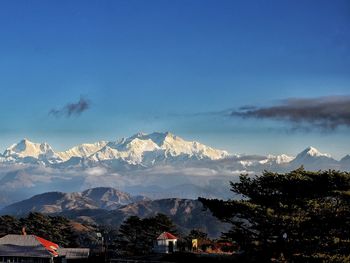 Scenic view of mountains against blue sky