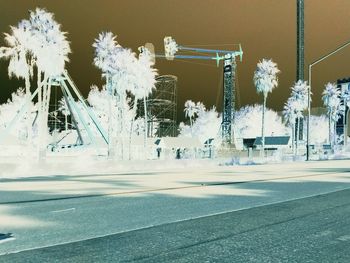 Cars on snow covered road in city