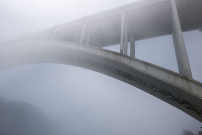 Low angle view of bridge in fog