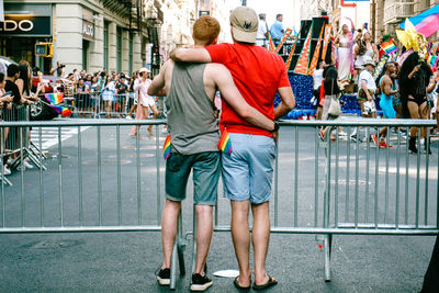 Rear view of people standing in city