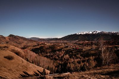 Scenic view of mountains against clear blue sky