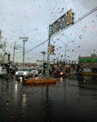 City seen through wet glass window during rainy season